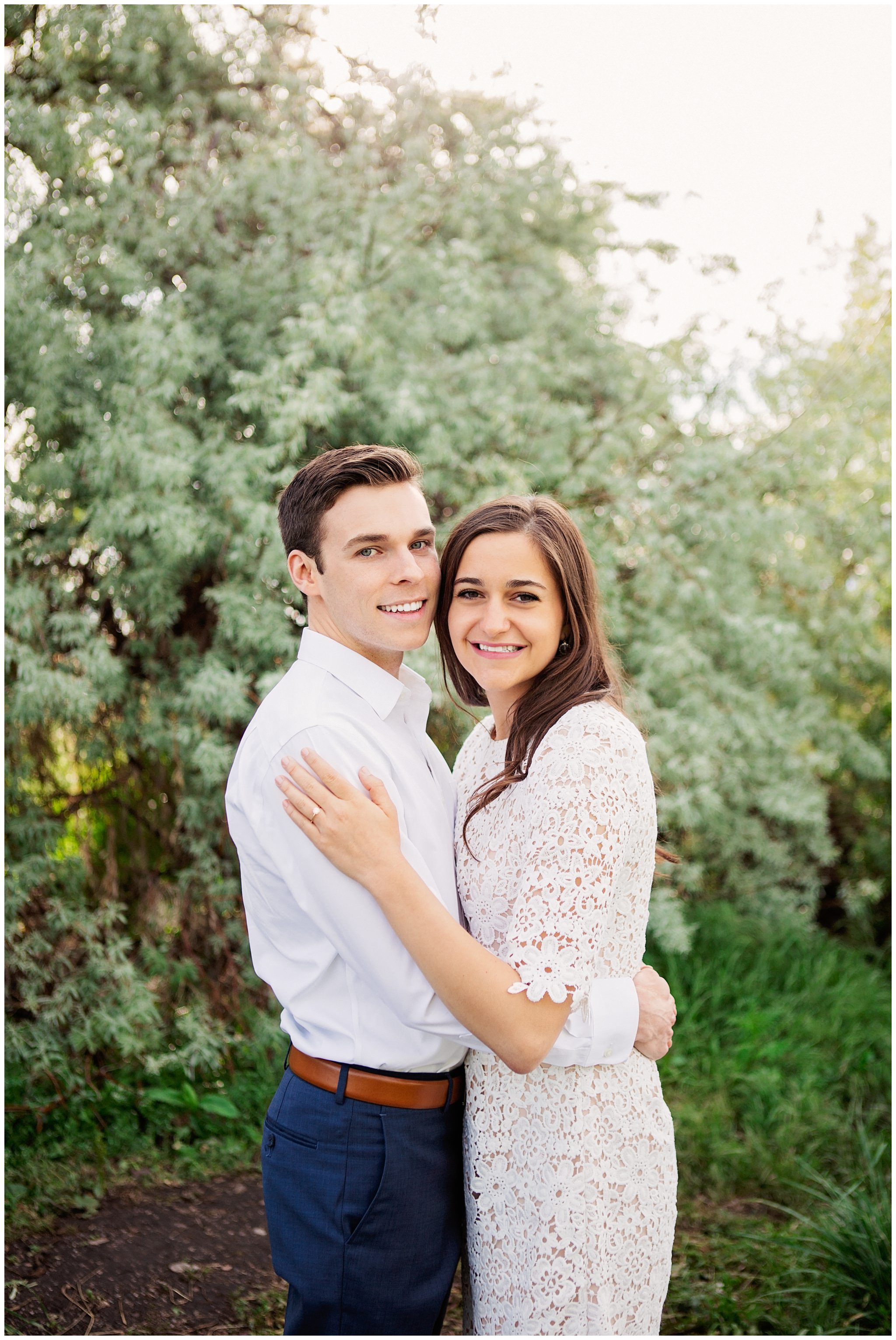 Couple smiling at camera for their engagement session in Salt Lake City Utah