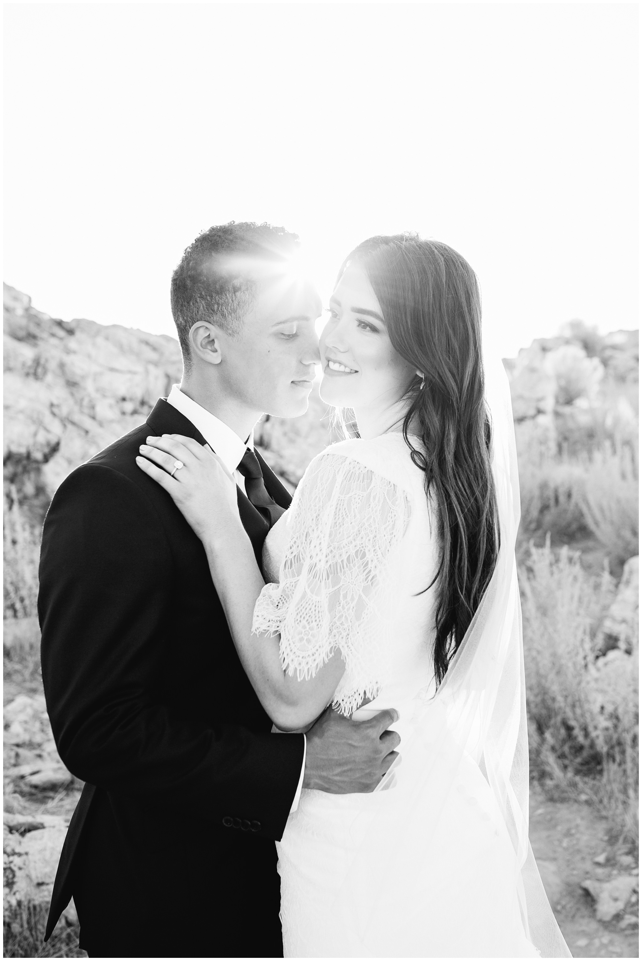 Groom tickling bride with his nose making her laugh for the wedding pictures in Utah