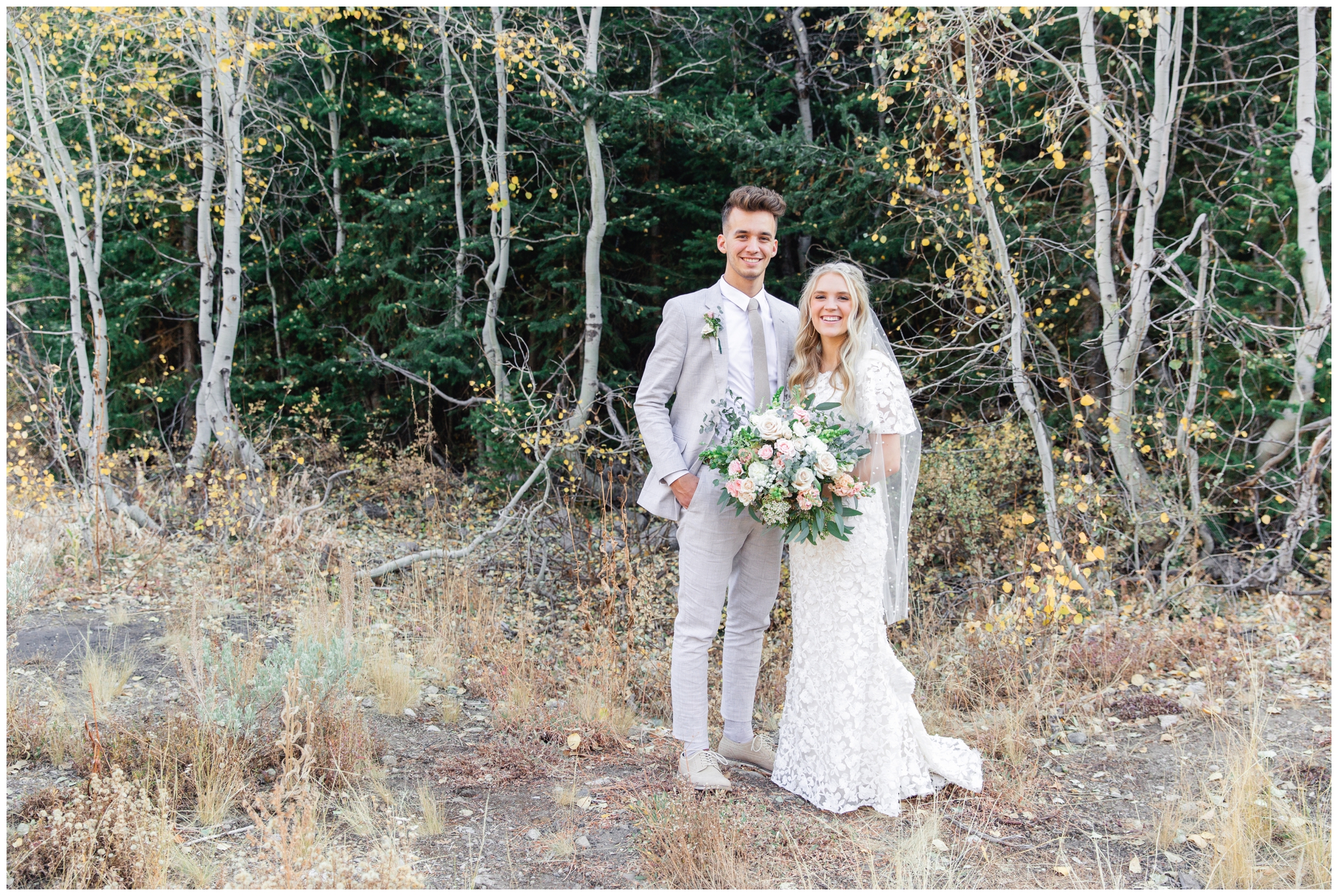 Bride and groom smiling at the camera at Jordan pines