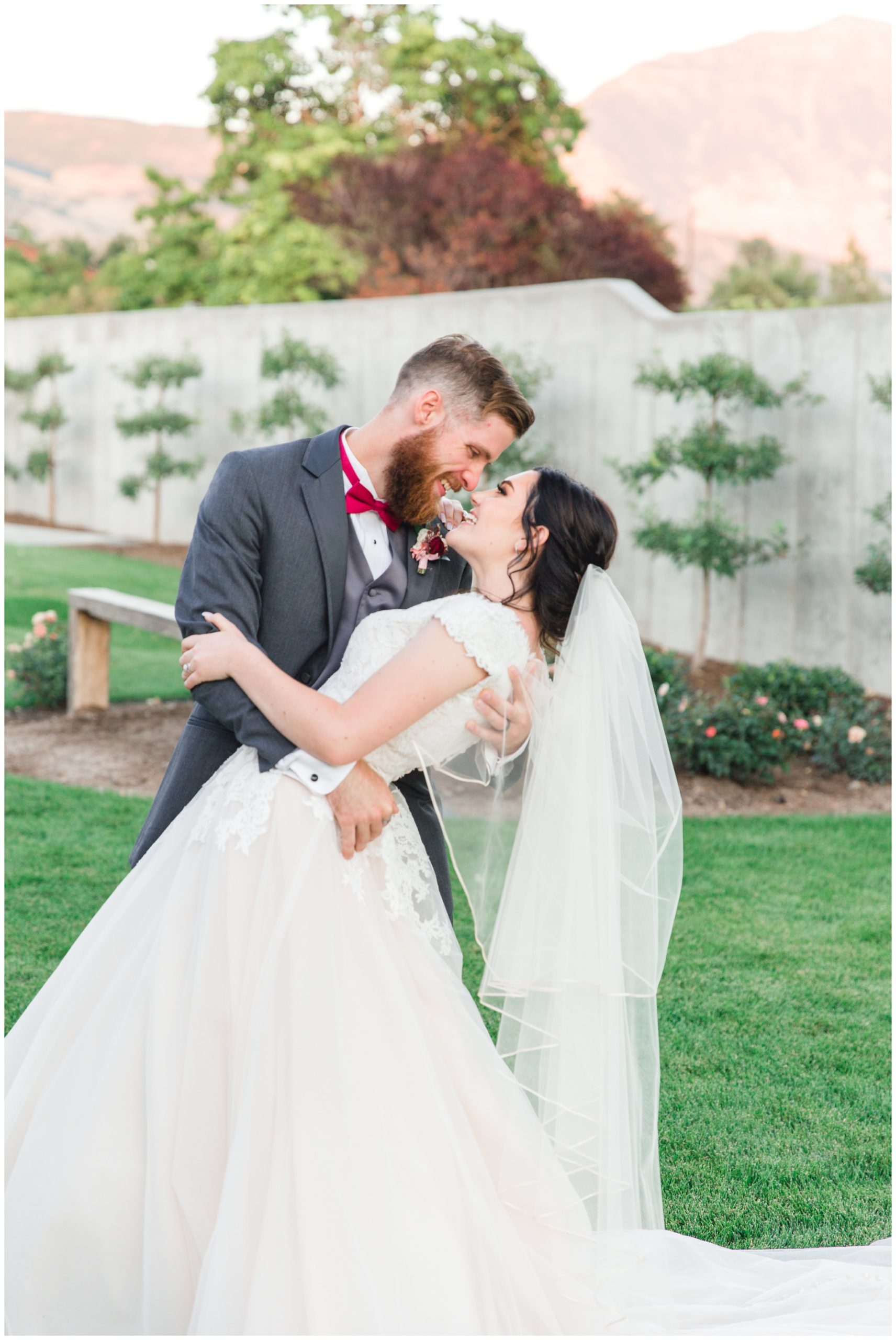 Groom dipping the bride at their wedding reception at the Wild Oak Wedding Venue in Lindon, Utah.