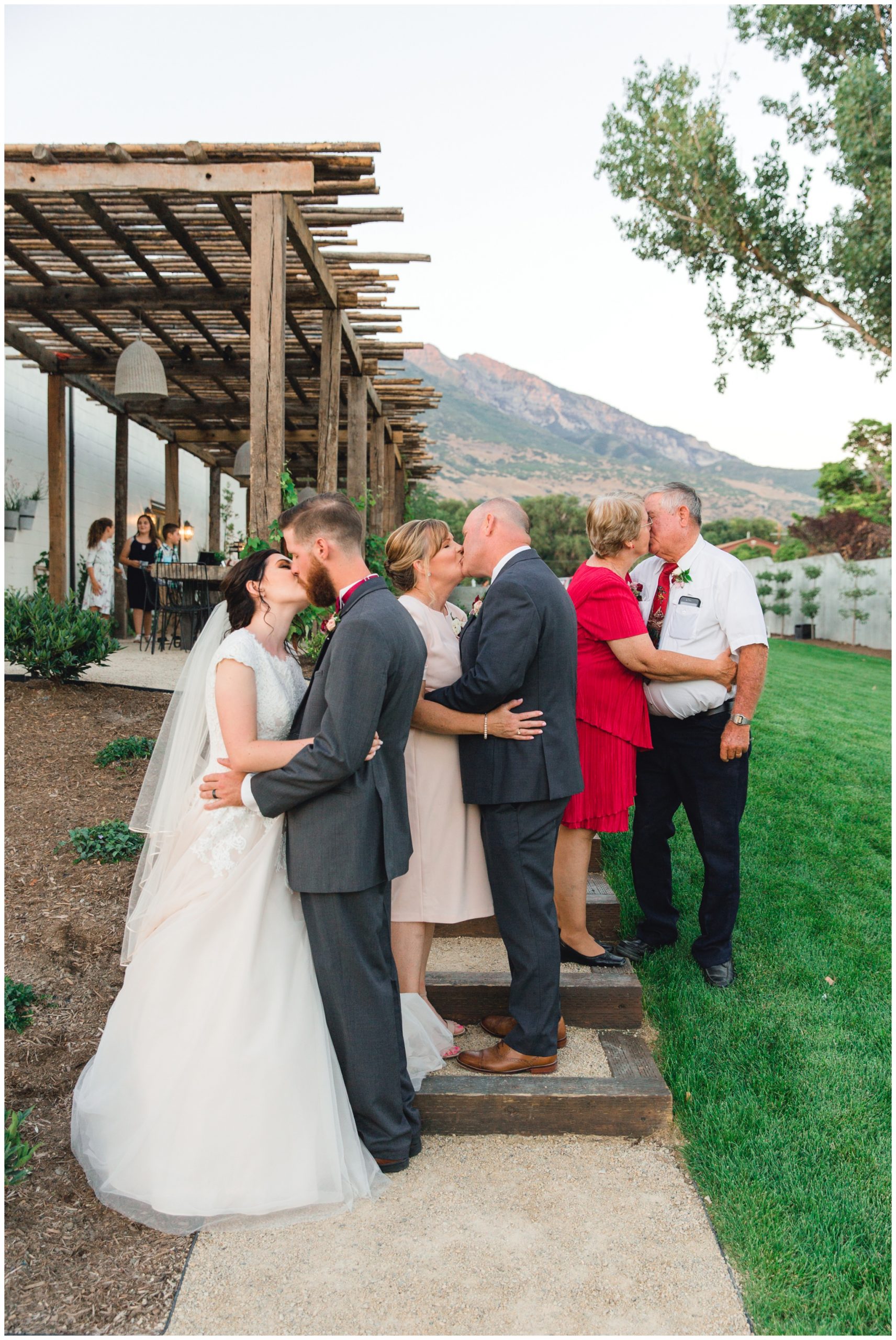 3 generations kissing their spouces. All of them share the same wedding date.