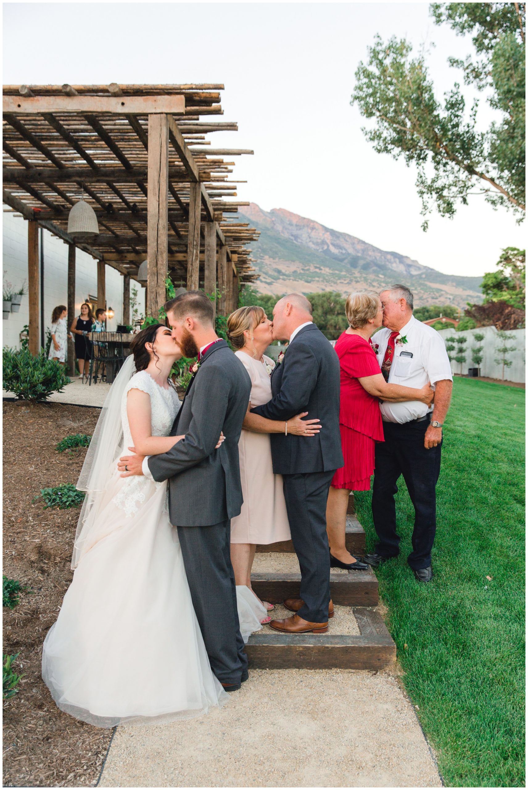 3 generations kissing their spouces. All of them share the same wedding date. 