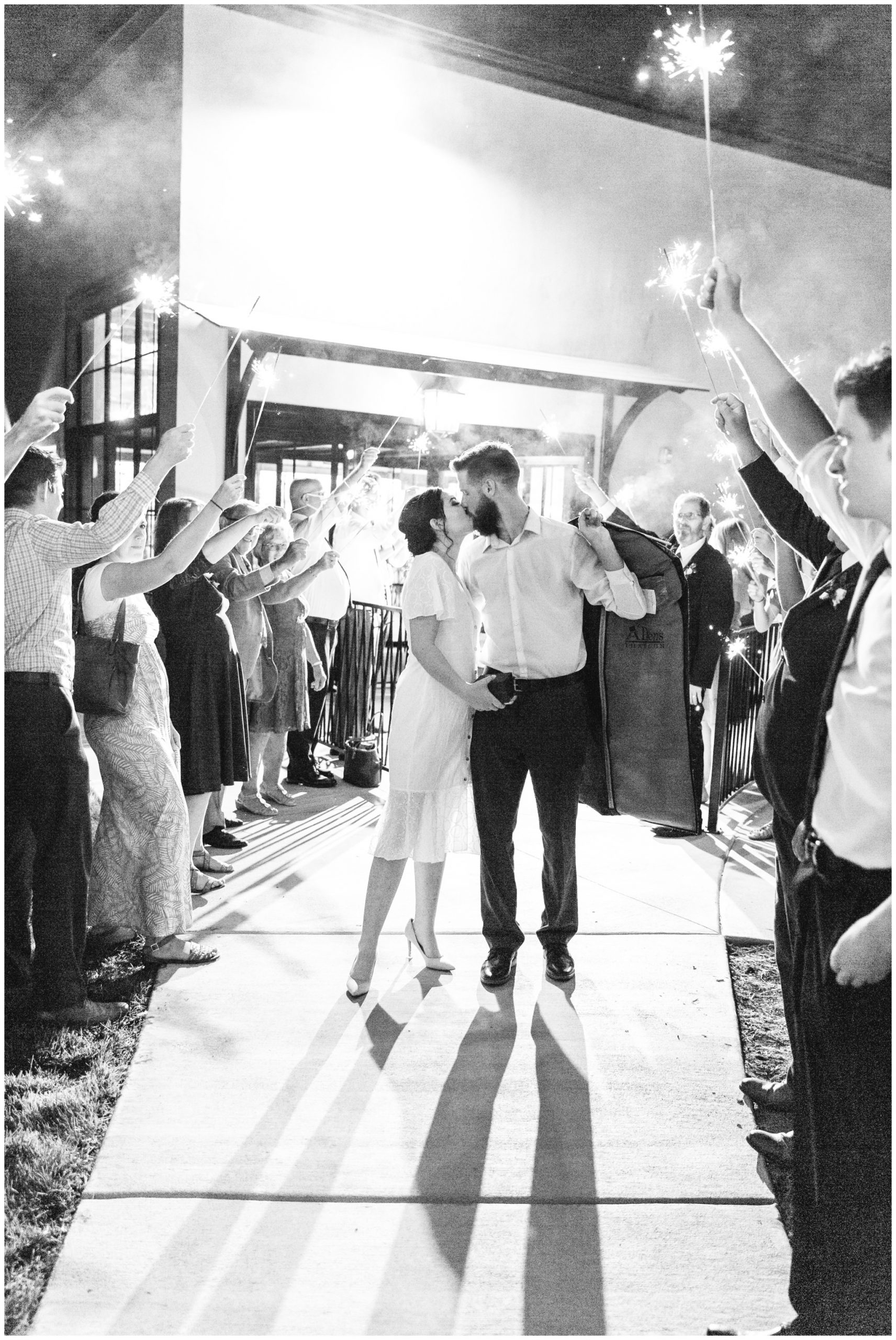 Bride and groom kissing during the sparkler exit at their wedding in Lindon Utah