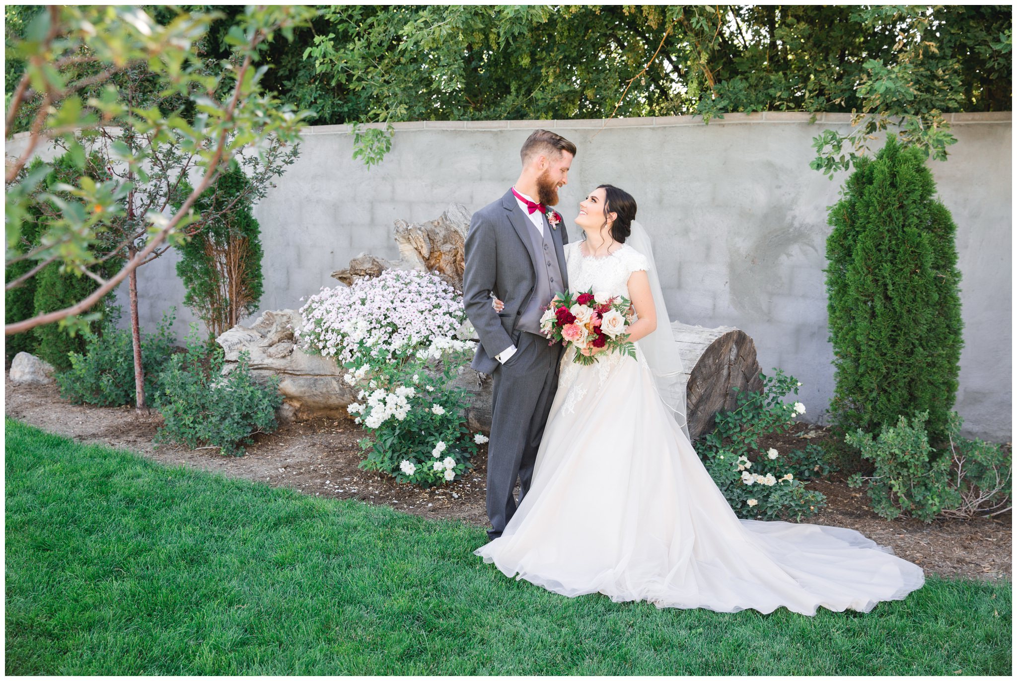 Bride and groom taking pictures outside at their wedding at the Wild Oak wedding venue in Lindon, Utah