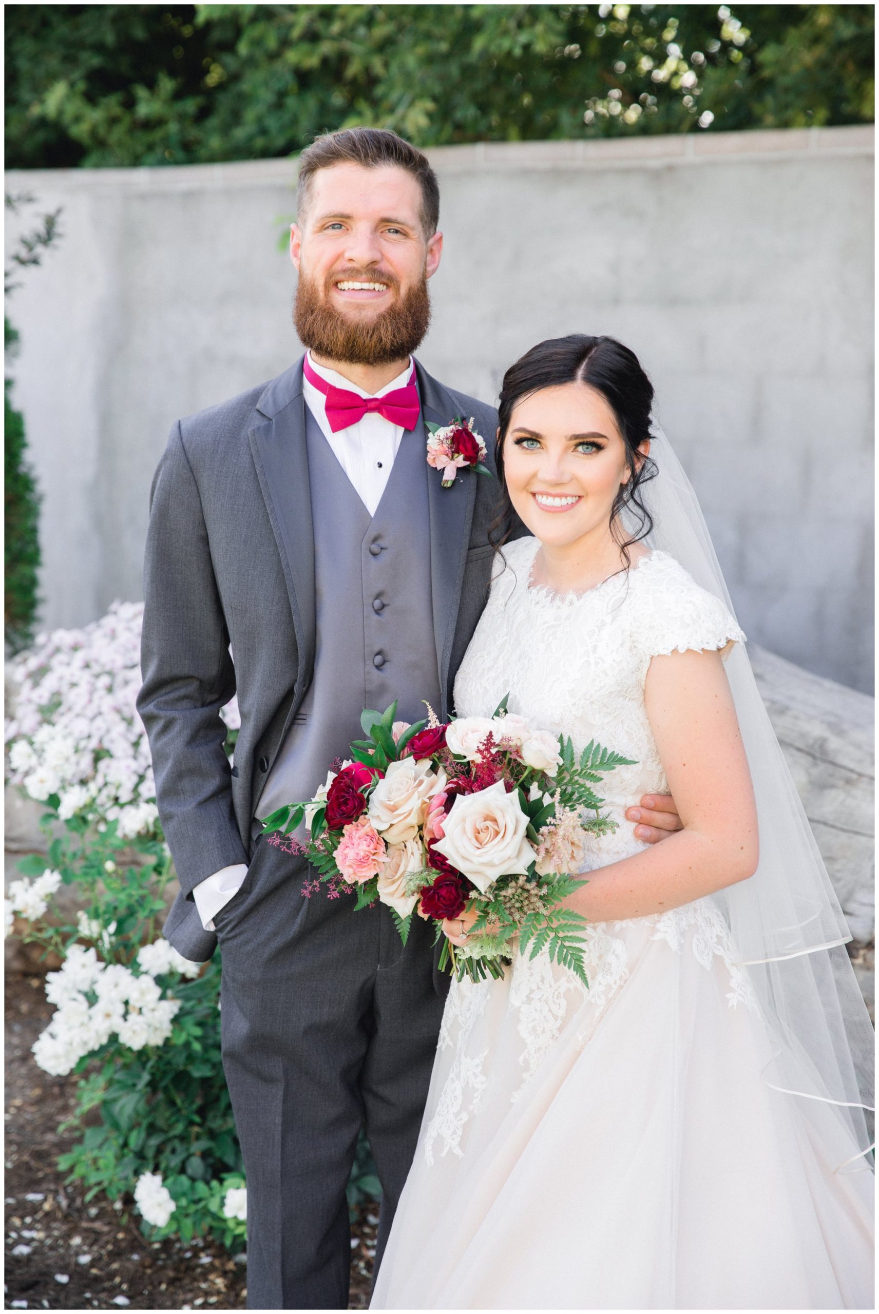 Bride and groom smiling at camera for their wedding pictures in Lindon, Utah.