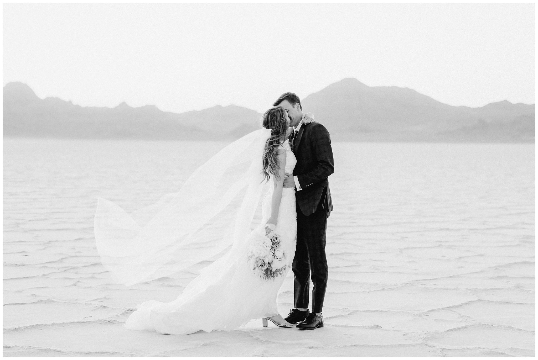 Utah salt flats with bride and groom kissing