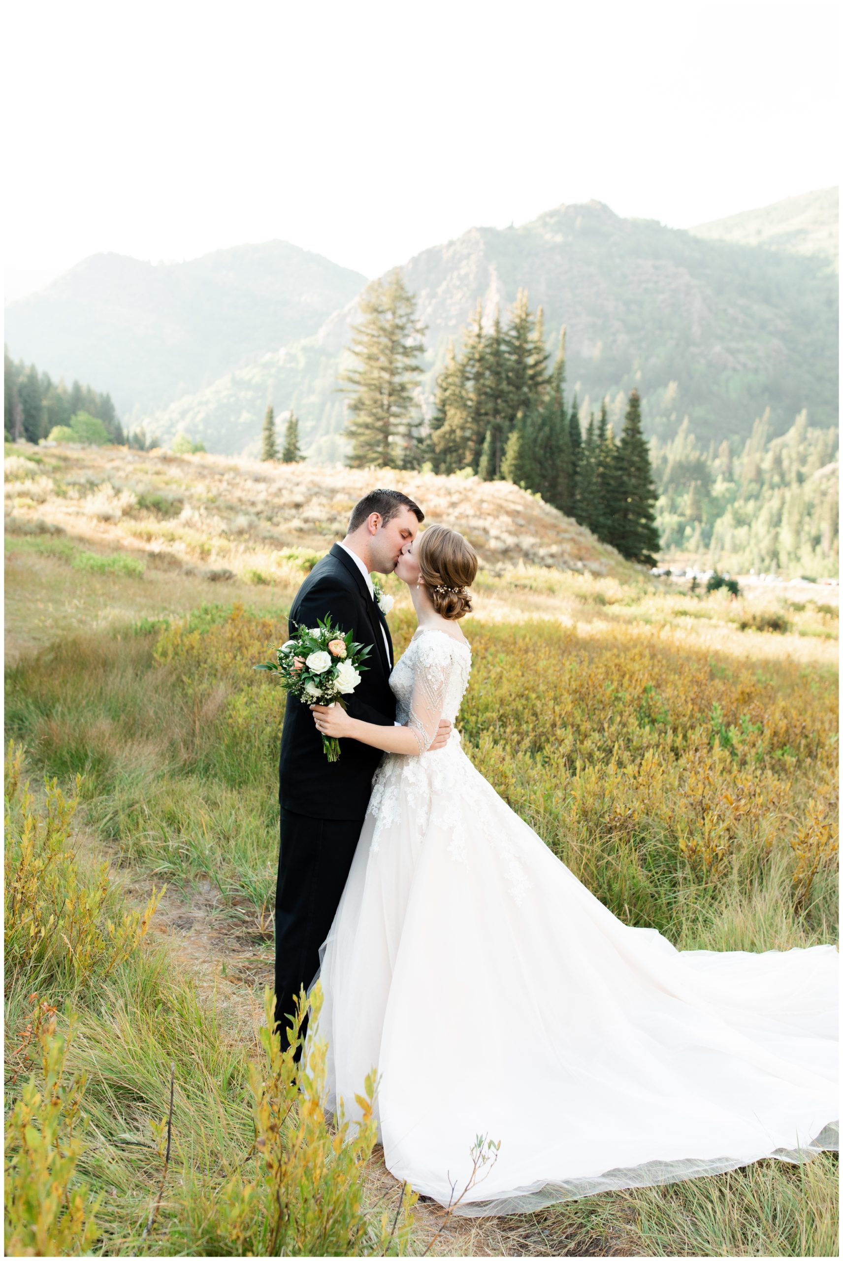 Bride and groom kissing in Utah Mountains
