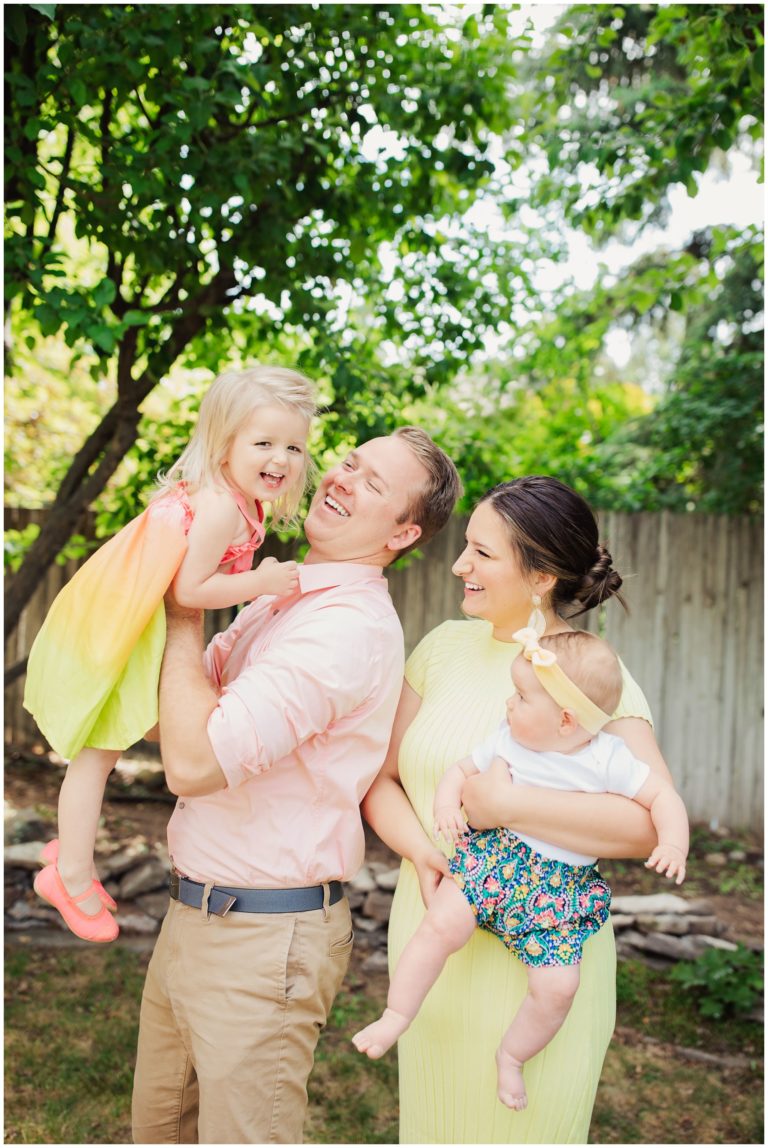 Family laughing while taking pictures in Lubbock Texas near Texas Tech