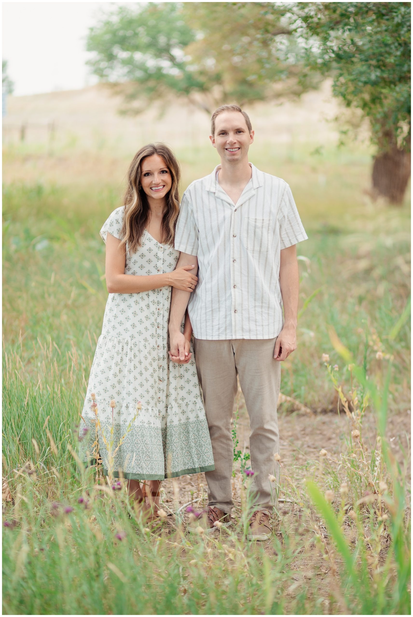 Mom and dad holding hands while taking pictures in Lubbock Texas