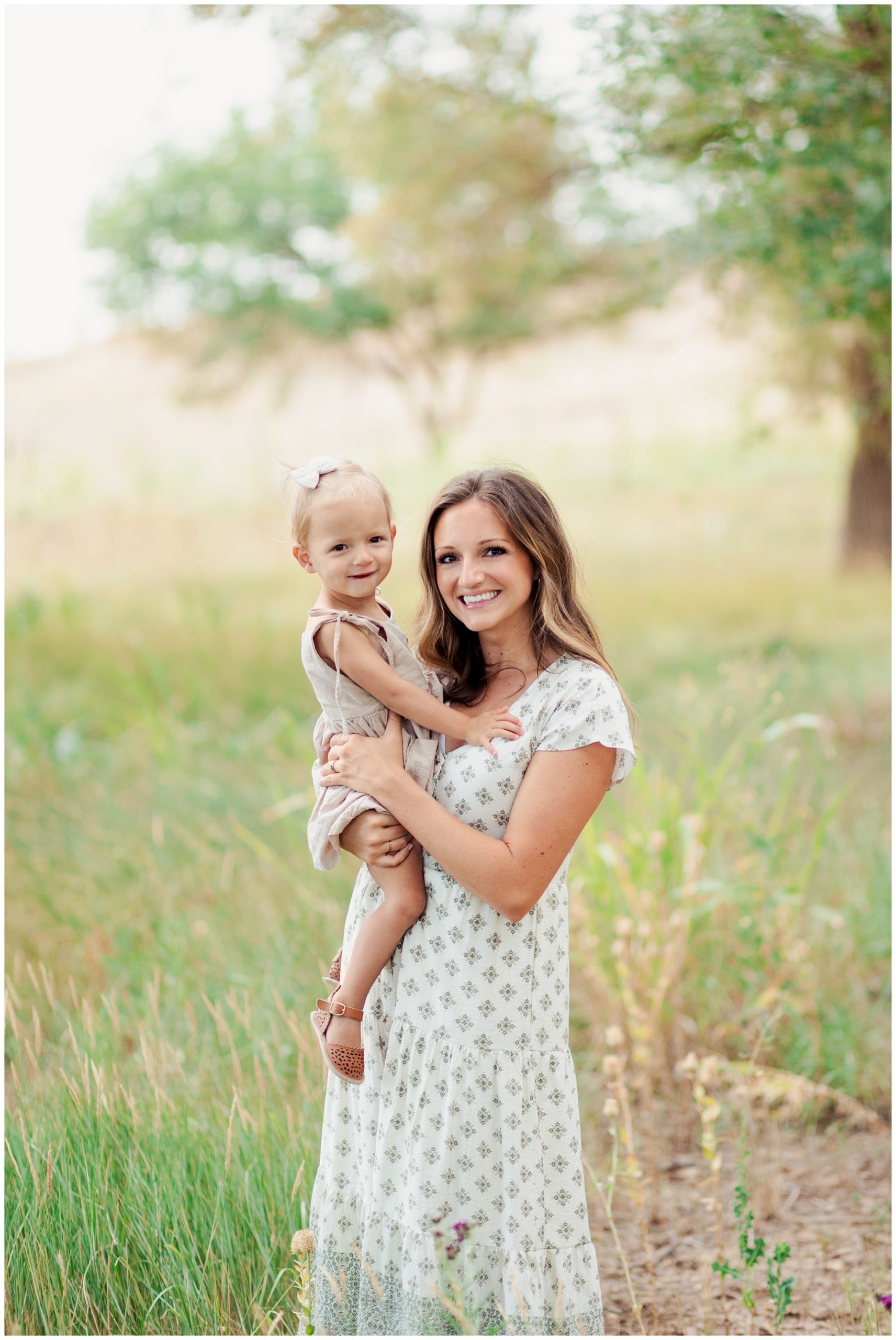 Mom and daughter smiling in field in Lubbock Texas